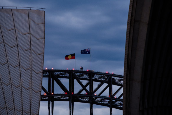 The Aboriginal flag flies atop the Sydney Harbour Bridge on Australia Day 2021.