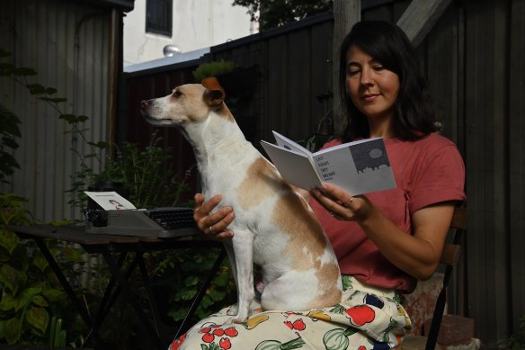 Illustrator Kim Siew looks back at one her many zines. She’s pictured with her dog, Alfie.