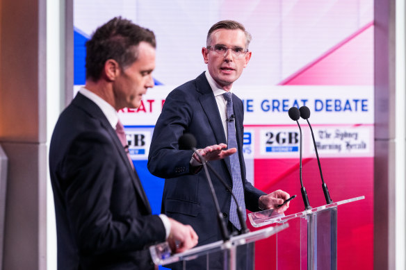 Dominic Perrottet gestures as he addresses Chris Minns.