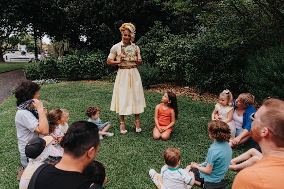 Courtney Act prepares to read their new book. 