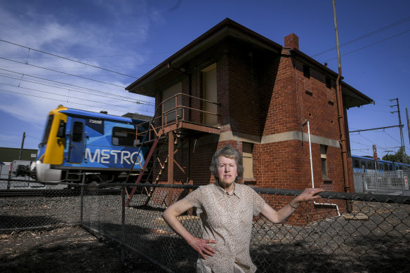 Marilyn Moore from Coburg's Historical Society in front of an old signal box set to be demolished to make way for sky rail.