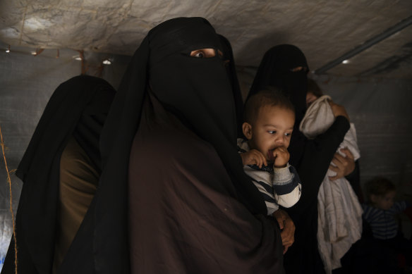 Al-Hawl detainee Zahra Ahmed holds her son Ibrahim. The Australian families are living in squalid conditions at the camp, which houses about 70,000 people.