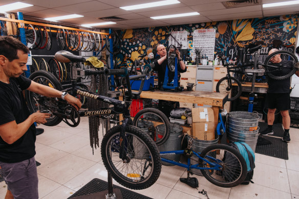 Volunteers Jose Quaglia, Anthony Klimpton and Tim Starr, at Revolve Recycling, who help fix bikes that are to be given away to disadvantaged children.