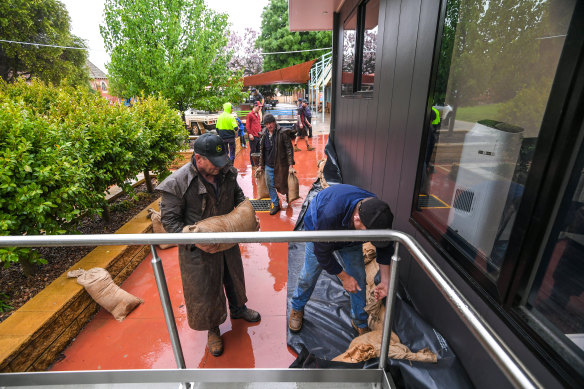 Community members sandbagging St Joseph’s Primary School in Rochester, which is unlikely to reopen this year. 