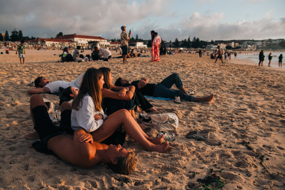 Mates enjoy the first sunrise of 2025 at Bondi Beach. 
