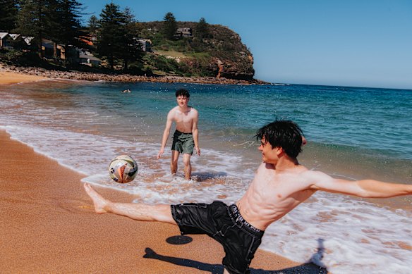 Lachlan Carlton and Jakob Stephenson soak up the warm spring temperatures at Avalon Beach last week.