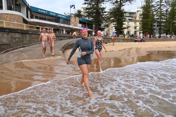 Heidi Wintermeyer, part of Manly's Bold and Beautiful swim group, enters the ocean.