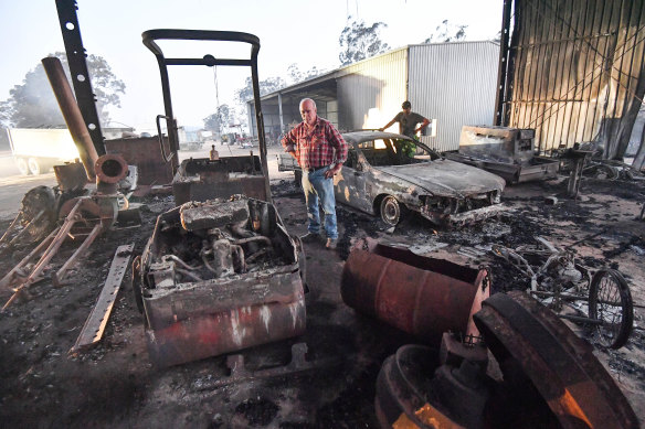 Peter Riley (front) and his son-in-law Simon Evvage at their fire-damaged Clifton Creek property. 