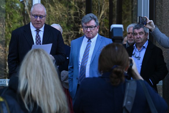 Solicitor Andrew O’Brien (left) reads a statement outside court on Friday morning.
