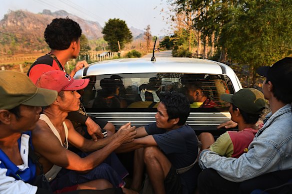 A group of men from Pu Lu Palaw village in Myanmar travel along a rural road in the Thai borderlands.