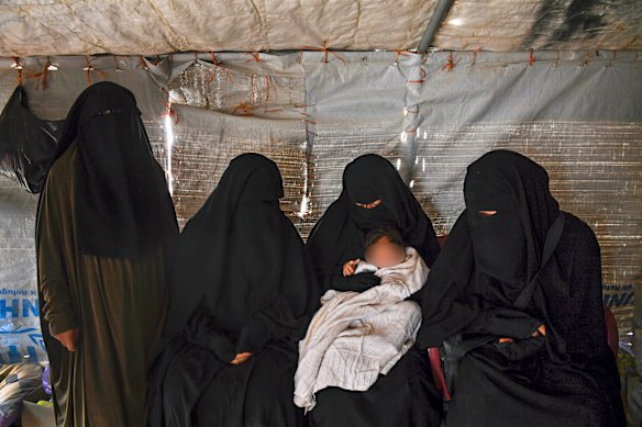 Zahra Ahmed holding her son in the al-Hawl camp in 2019.