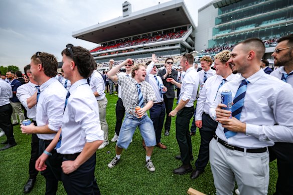Punters cheer home a winner at Flemington on Cox Plate day.
