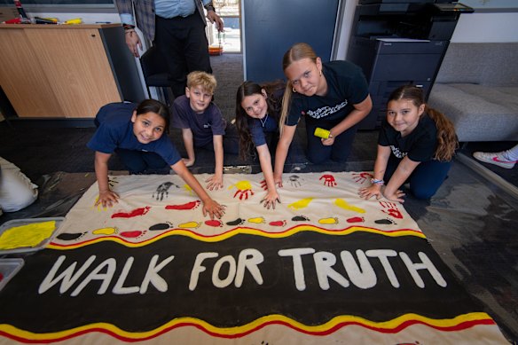 Reservoir East Primary School children put the finishing touches on the “Walk for truth” banner.
