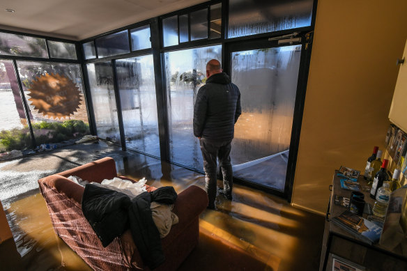 Rochester Motel owner Matt Keating watches the flood outside. 