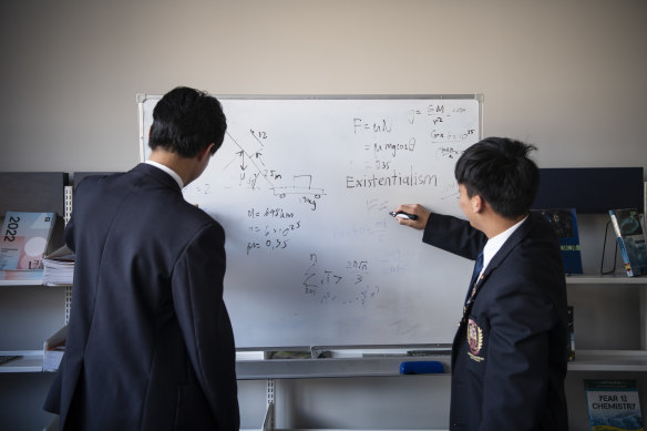 Students practise physics together.