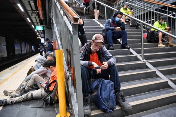 Early morning commuters wait for their trains at Town Hall station.