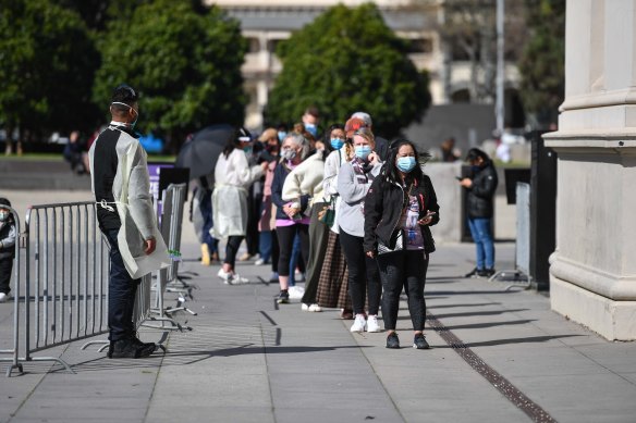 People queue to be vaccinated at the Royal Exhibition Building in Carlton at the weekend.