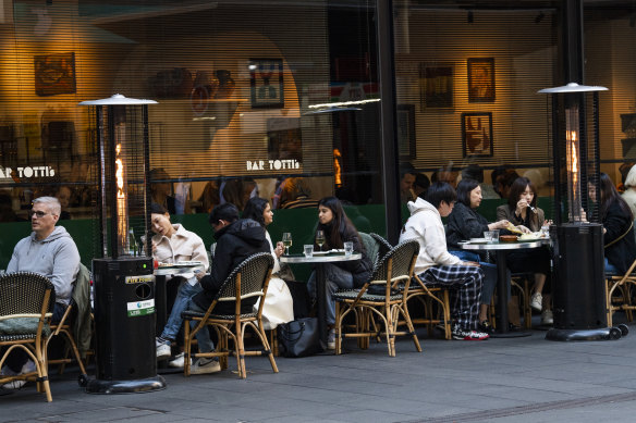 People eating and drinking at Bar Totti’s on George Street. The ban on standing while drinking outdoors in the City of Sydney Council area is set to end. 
