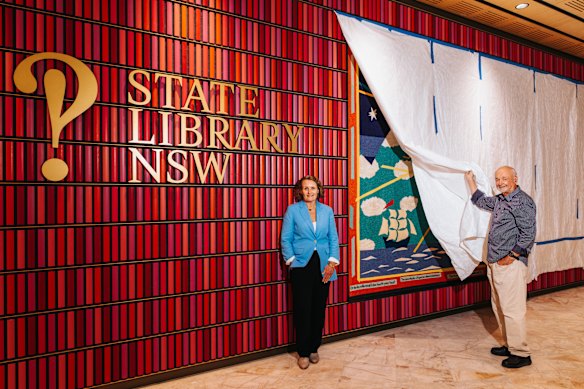 State Librarian Caroline Butler-Bowdon and award-winning architect Andrew Andersons take a sneak look at the Martin Sharp tapestry that has been restored to its rightful place after a $15 million redesign.