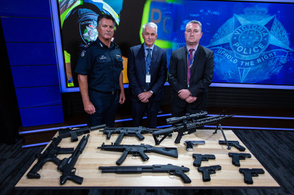 Assistant Commissioner Bob Hill, Detective Superintendent Peter Brigham (middle) and Detective Inspector Mick Daly with a cache of seized firearms