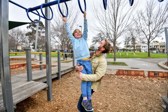 Toby Cummings and his son Louis, 8, enjoy themselves at Curtain Square park on Monday ahead of the announcement of tightened COVID-19 restriction that will, among other things, result in the closure of playgrounds.