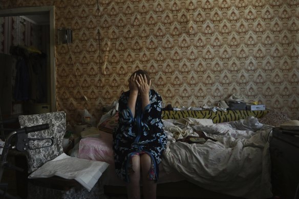 Sittting in her apartment in Avdiyivka and unable to leave, Liudmyla Rudska, 64, listens to artillery outside and wipes tears from her face when she recounts the impact of living on the contact line for the past eight years.