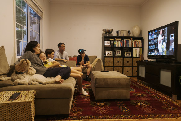 Emma McCormack and family settle in to watch evening TV at home in Hunters Hill. 