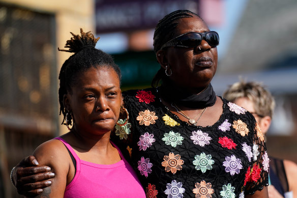 People gather outside the scene of a shooting at a supermarket, in Buffalo, New York.