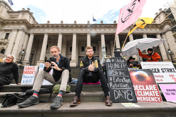 Another climate protester, Daniel Bleakley (centre), in front of Parliament on day eight of his 10-day hunger strike in November.