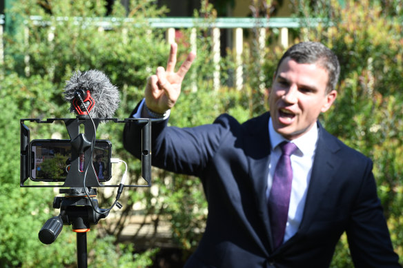 Auction clearance rates have plunged to record lows as bans on live auctions push real estate agents to run online sales. McGrath auctioneer Troy Malcolm takes bids during a live online auction on Saturday.