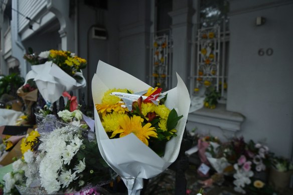 A Qantas plane toy sits on top of a bouquet of flowers left at the Paddington terrace in tribute to Jesse Baird and Luke Davies.