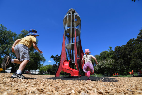 Magnet for kids: Henry and Eloise Gannon shoot towards the rocket play tower in Central Gardens, Hawthorn on Wednesday.