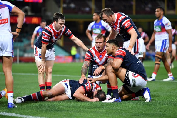 Roosters players show their concern for Boyd Cordner after the skipper went down against the Knights.