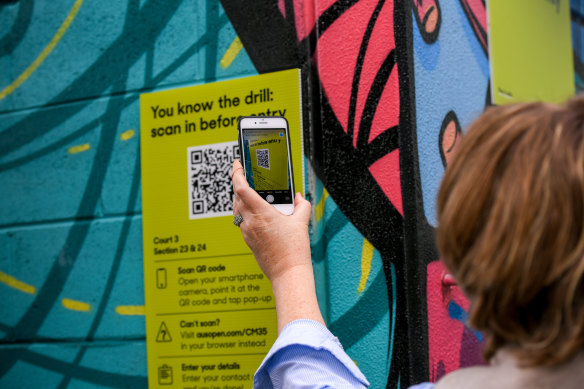 Scanning the QR code outside court three at Melbourne Park during the Australian Open.