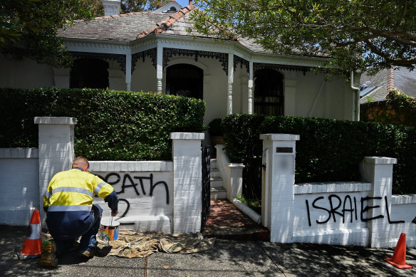 The clean-up begins on another house that was the target of graffiti.