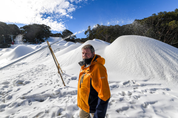 Mount Baw Baw general manager Andrew Tingate beside the mounds of manmade snow. 