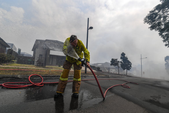 A firefighter washes hiimself down.