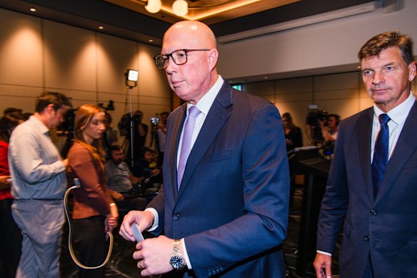 Dutton walks away after the press conference ends.