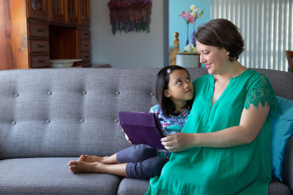 Mother Jessica Dunn with her daughter Alira share some screen time on Alira’s tablet. 