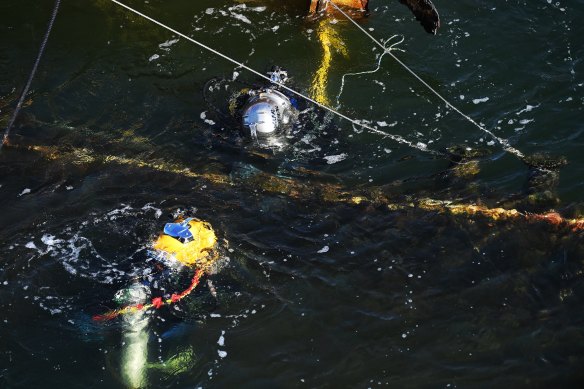 Divers work to dismantle the vessel.