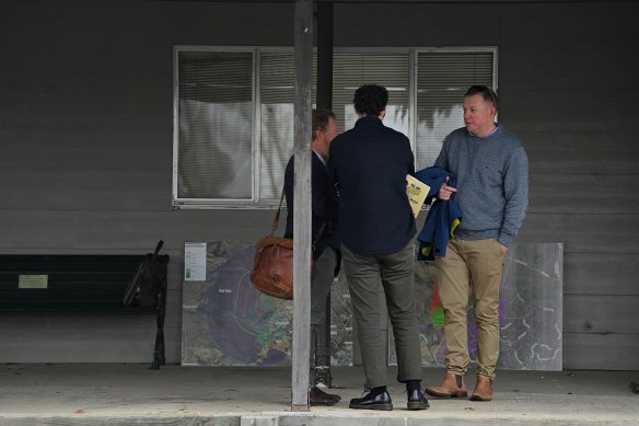 Ben Cranston (right), the development manager for the proposed Wallaroo Solar Farm, arrives at the public meeting.