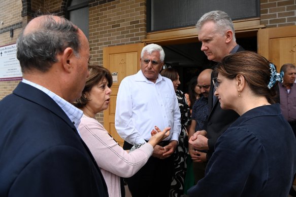 Palestinian Christian Maha Tarazi, second from left, talks with federal cabinet minister Tony Burke outside the Saints Peter and Paul Orthodox Church on Christmas Day.