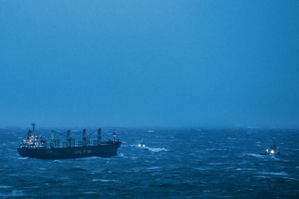 Three tugboats tow the MV Portland Bay to safety.