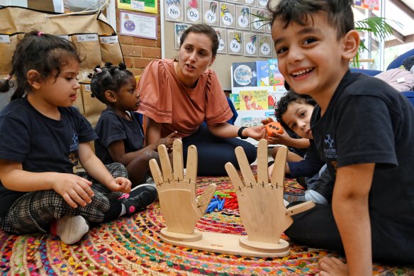 Teacher Tatiana Burmuzovski works through some basic number skills with children at Punchbowl Public Preschool.