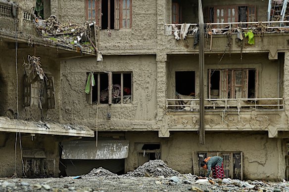 A woman among destroyed buildings in Betrawoti, which was severely affected by the Nepal flash flood that has killed more than a thousand people. Thousands are still missing. 