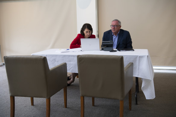 Premier Gladys Berejiklian and Minister for Health Brad Hazzard during a video hook up for Wednesday's crisis cabinet meeting. 