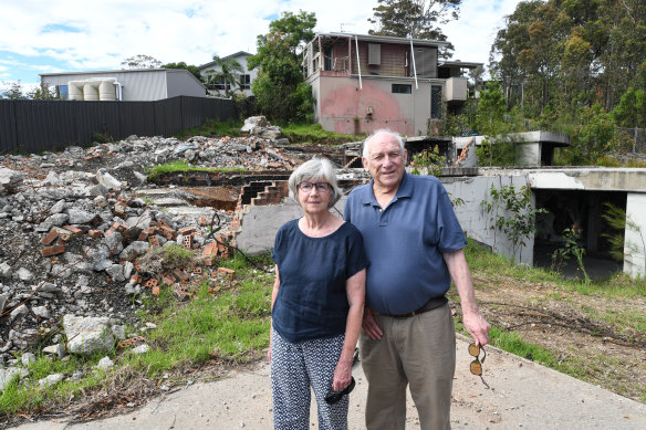 Susan Magnay and Philip Bull in front of the ruins of their home in Malua Bay.