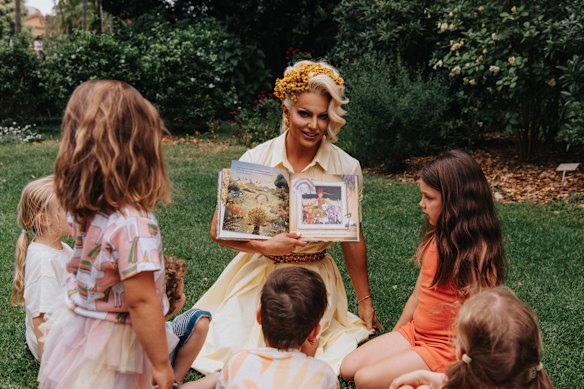Courtney Act reading their book Confetti and the Rainbow Garden.