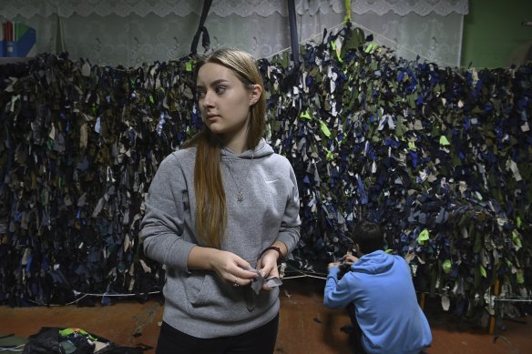 In her final year of high school, Tetiana Onopriienko, 16, volunteers making camouflage nets in a community shelter in Uman to aid the Ukrainian resistance.