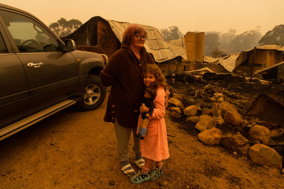 Barbara Rugendyke and her adopted daughter Sarah, who holds a doll, the only item she took with her when the family evacuated on Tuesday morning.